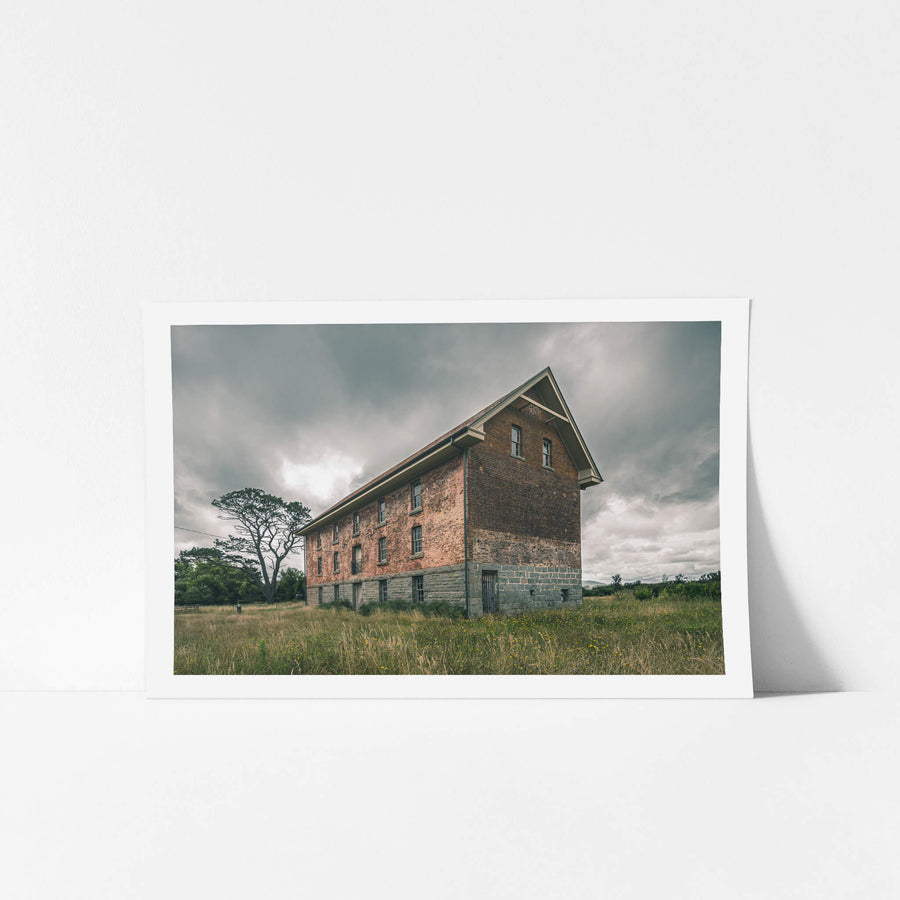 End of the Mill at Mill Pond Farm, a two-storey brick and bluestone building stands alone in open grassland.