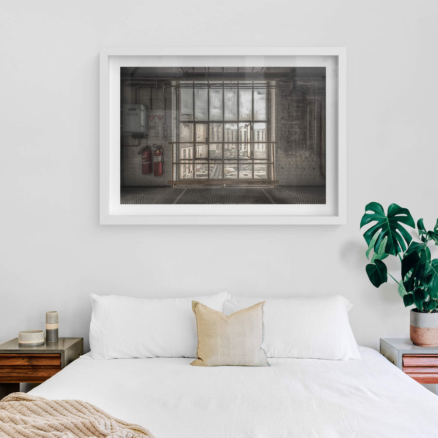 B to A at Morwell Power Station, a steel-framed window stretches floor to ceiling, divided into a grid of thick panes.