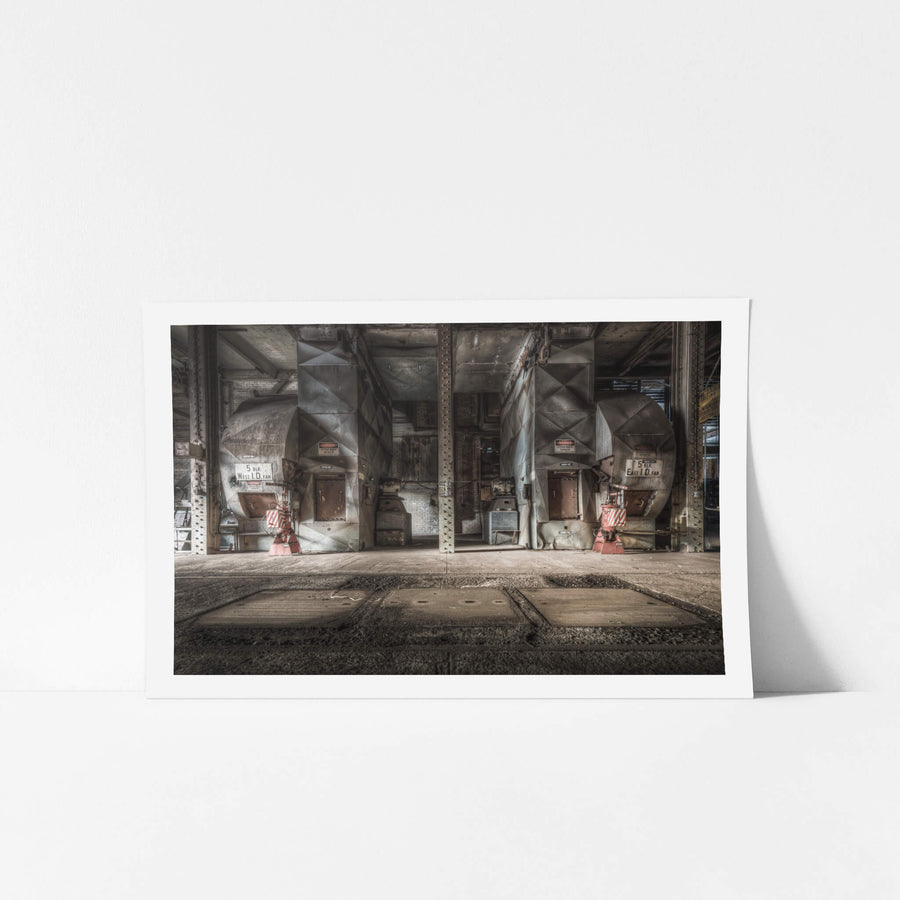 Blowers at Morwell Power Station, two induced-draft fans sit in mirrored bays either side of a riveted steel column.