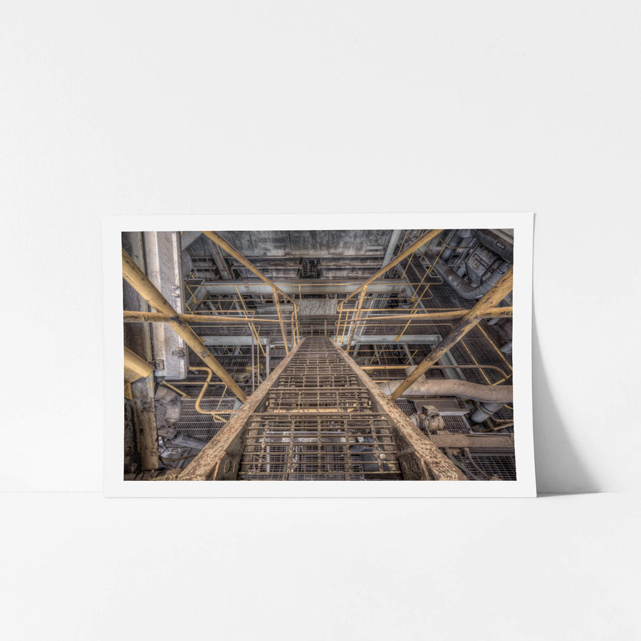 Descent at Morwell Power Station, a steel grate staircase climbs steeply between levels inside the boiler house.