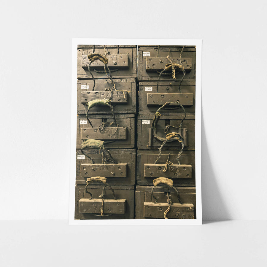 Crate Stack at Newington Armory, military ammunition crates stacked in two tight columns, olive-drab paint thick over heavy.