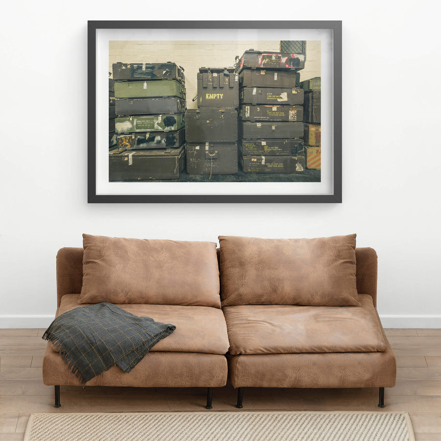 Crates at Newington Armory, military munitions crates stacked three columns high against a whitewashed brick wall.