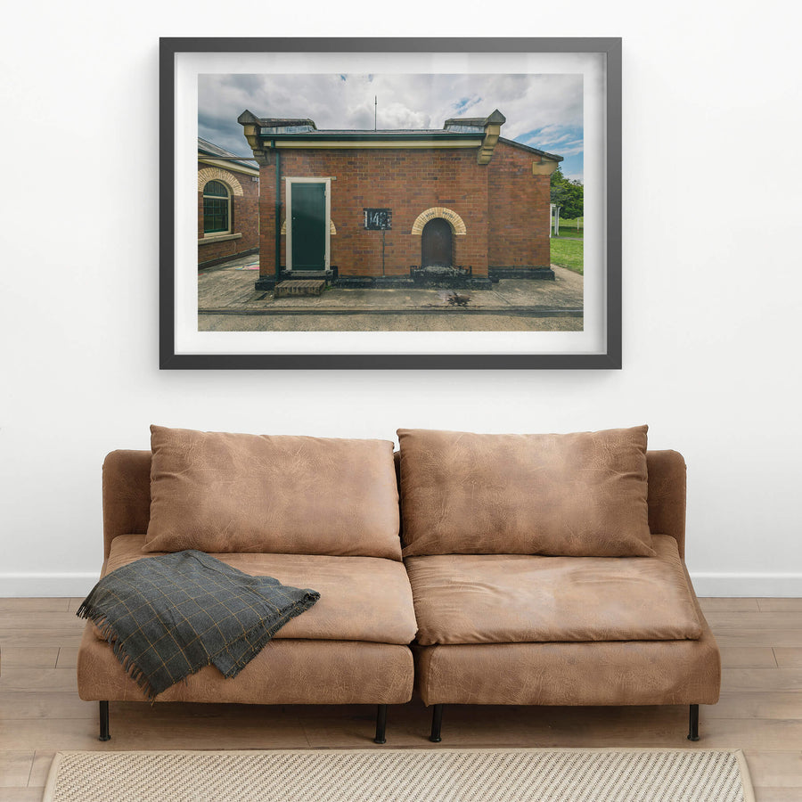 Issue Hatch at Newington Armory, a squat red-brick building sits square against a concrete apron.