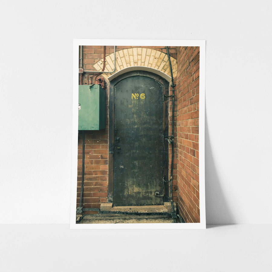 Magazine Door 6 at Newington Armory, a heavy steel door sits recessed into red brick.