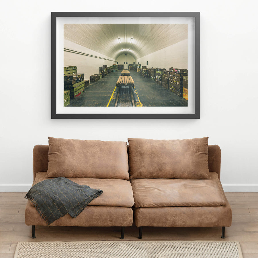 Magazine Interior at Newington Armory, a barrel-vaulted ceiling of whitewashed brick curves over rows of military ordnance.