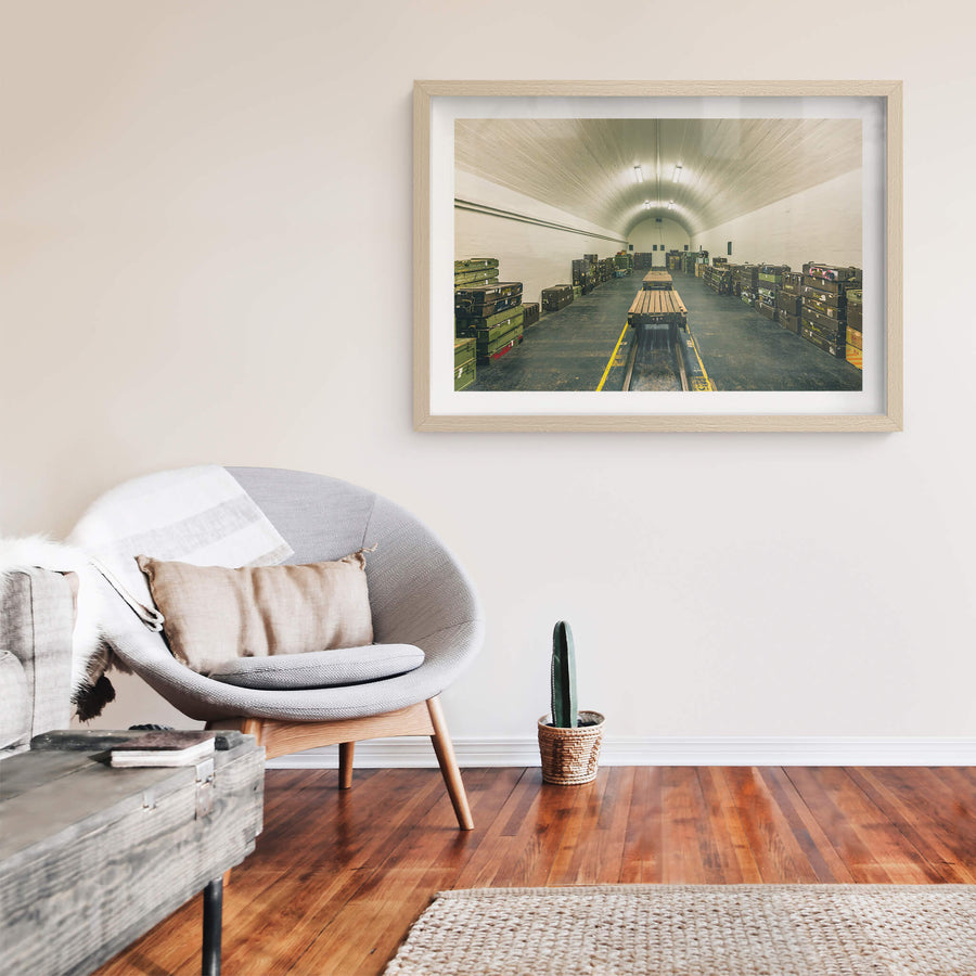 Magazine Interior at Newington Armory, a barrel-vaulted ceiling of whitewashed brick curves over rows of military ordnance.