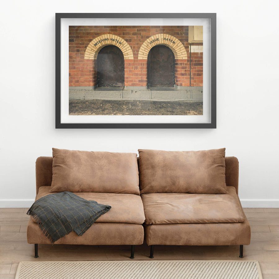 Recieving Issue at Newington Armory, two arched hatches sit side by side in a red brick wall.