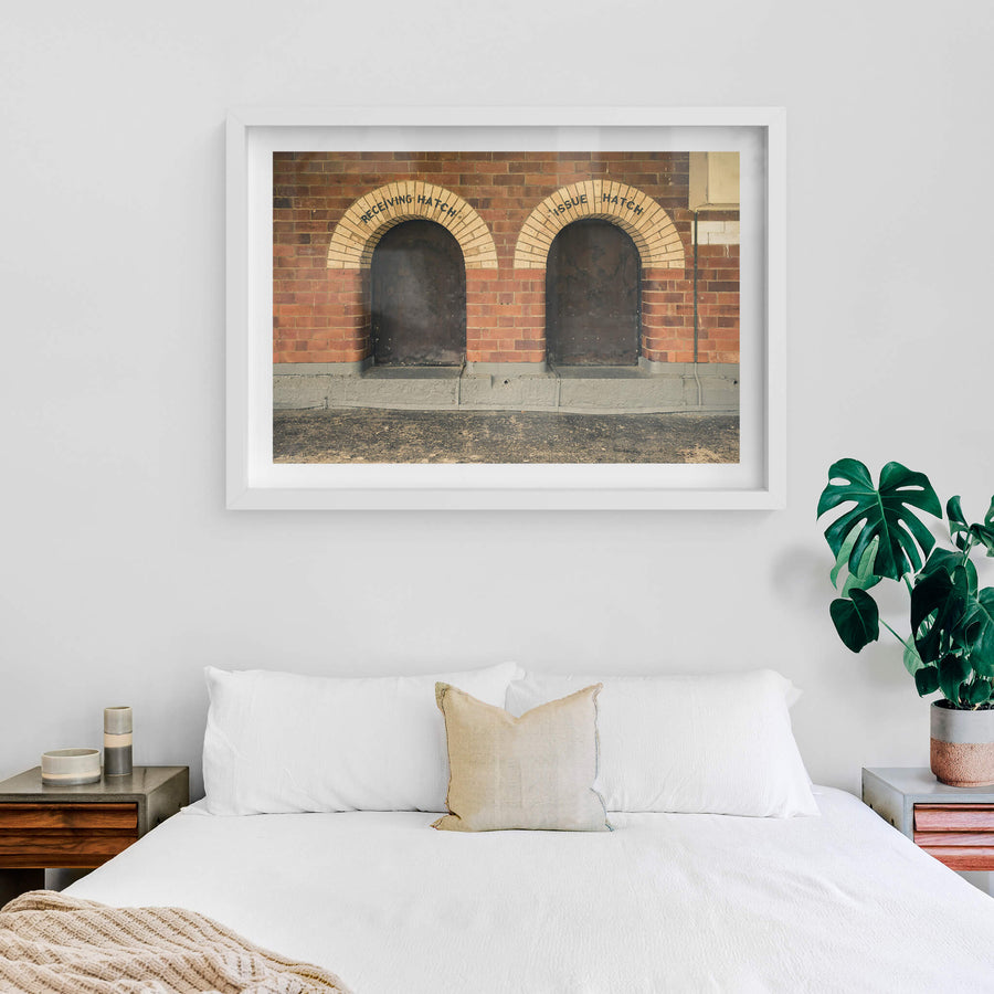 Recieving Issue at Newington Armory, two arched hatches sit side by side in a red brick wall.
