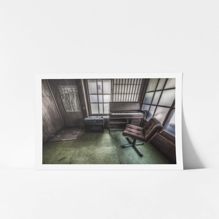 Studio at Nichitsu Mining Village, a plaid swivel chair faces a compact electric organ in the corner of a small.