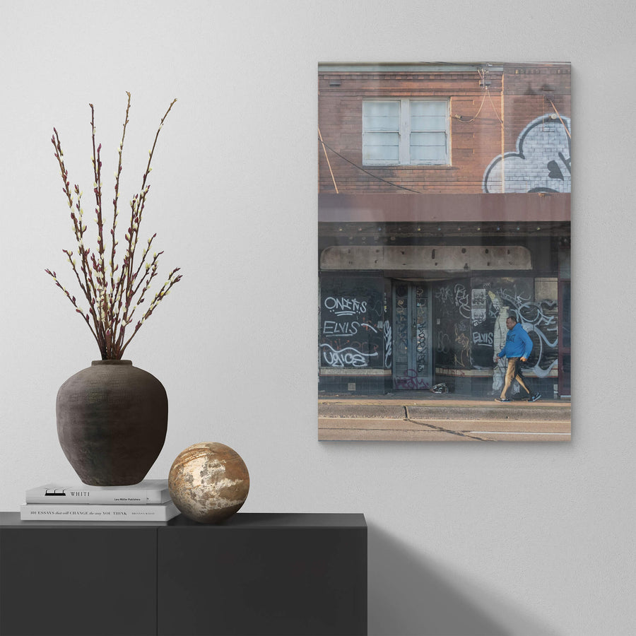Passer By at Parramatta Road, a two-storey brick building sits hard against Parramatta Road.