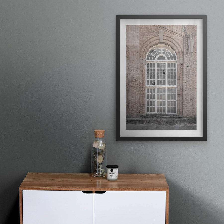 Arched Window at Portland Cement Works, a tall arched window set deep into a brick facade.