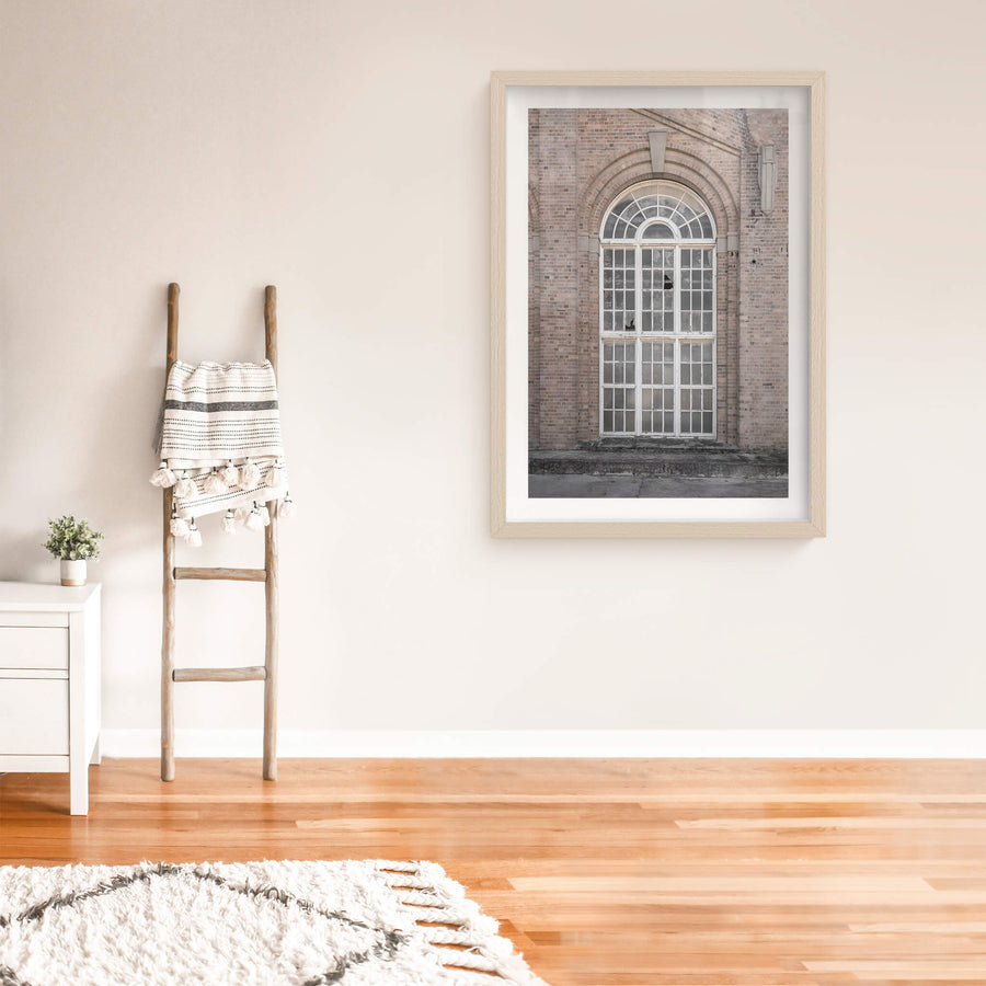 Arched Window at Portland Cement Works, a tall arched window set deep into a brick facade.