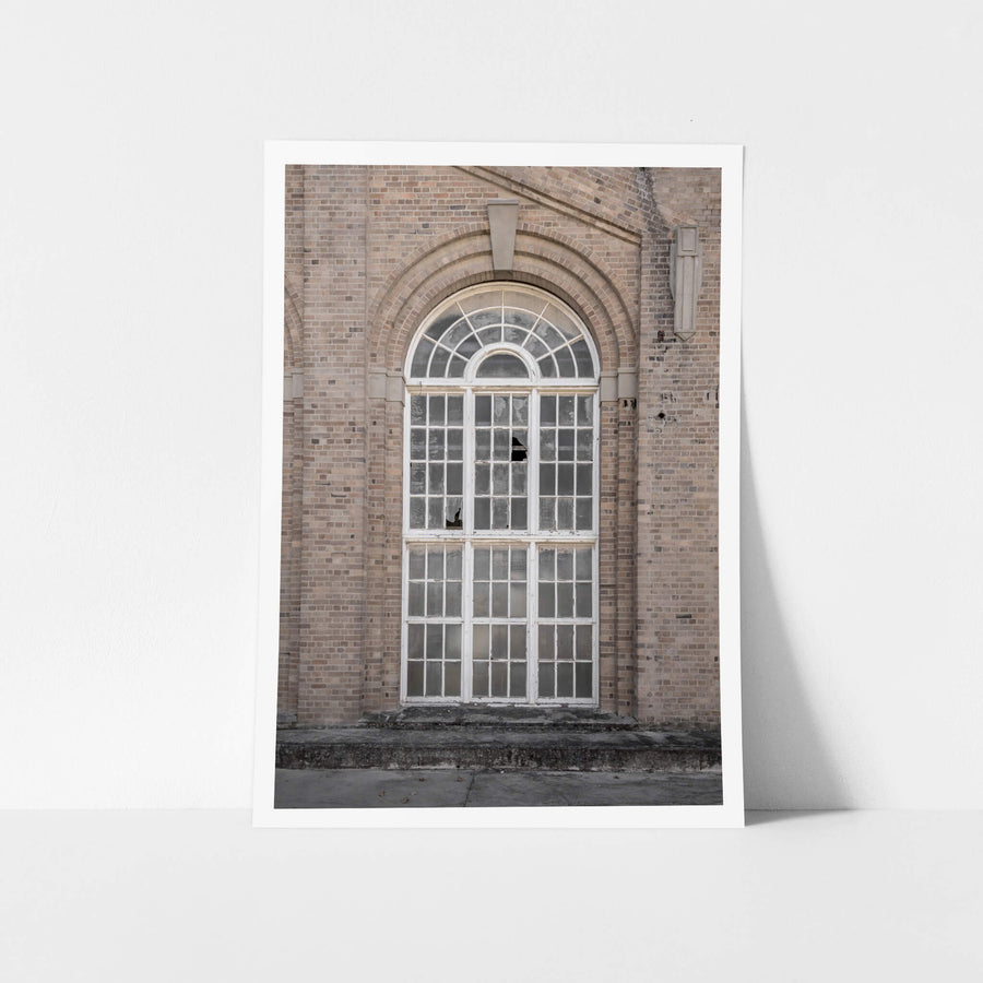 Arched Window at Portland Cement Works, a tall arched window set deep into a brick facade.