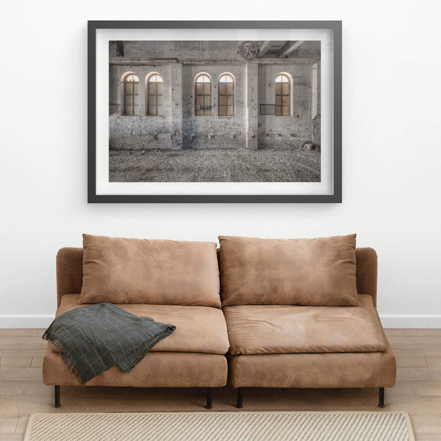 Boarded Arches at Portland Cement Works, three arched windows line the interior brick wall, their lower panes boarded.