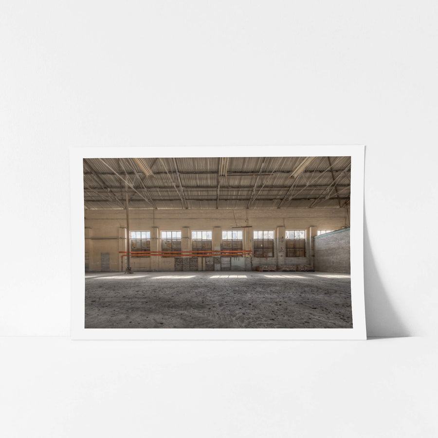 Cross Machine Shop at Portland Cement Works, a wide industrial floor stretches towards a row of steel-framed windows.
