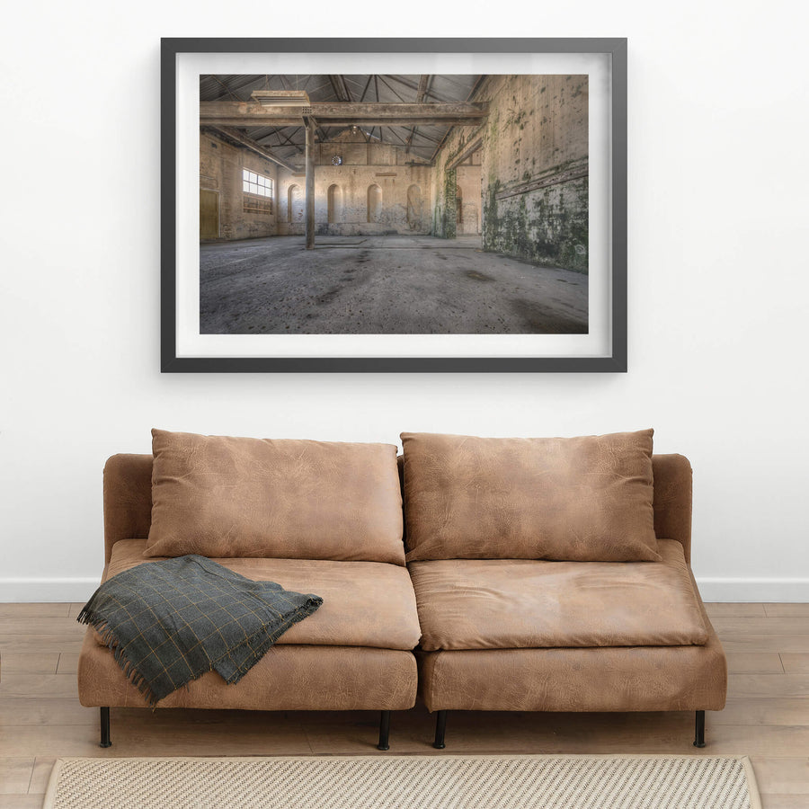 Green Wall at Portland Cement Works, a single steel column rises from a stained concrete floor, supporting iron roof.