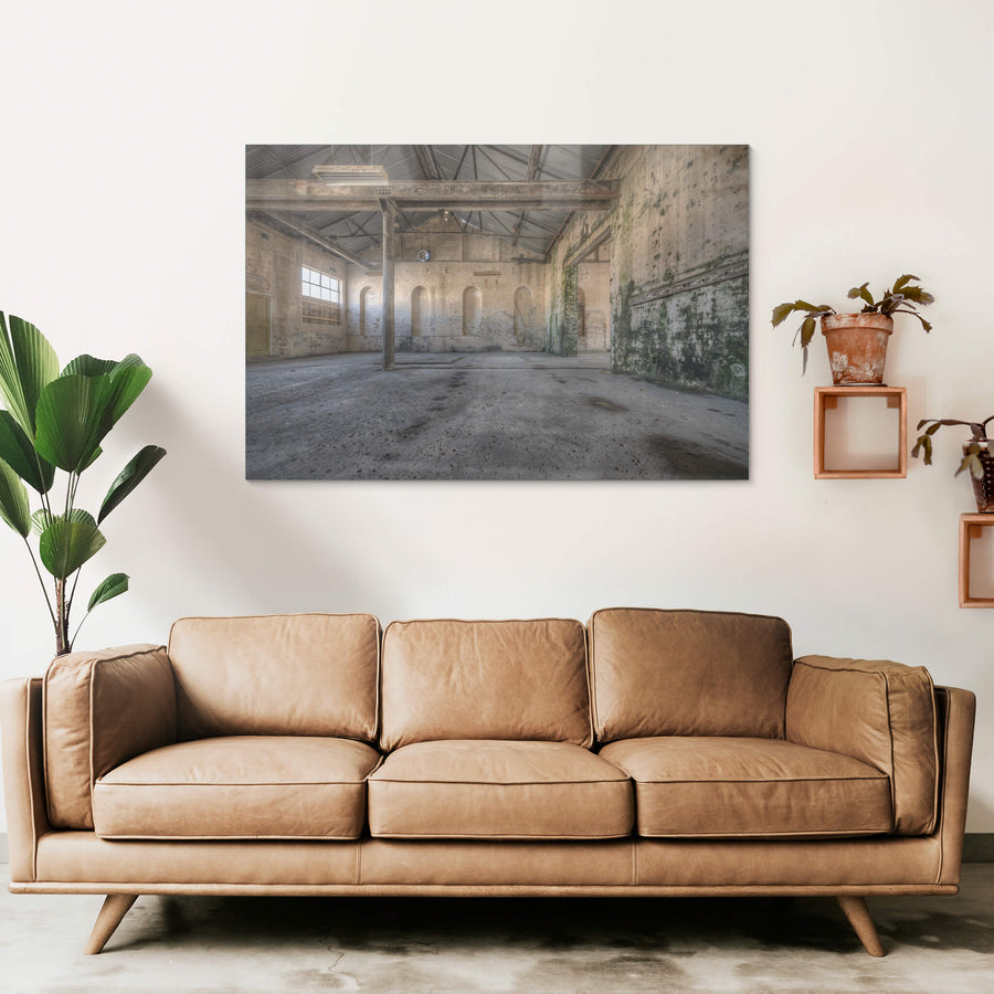 Green Wall at Portland Cement Works, a single steel column rises from a stained concrete floor, supporting iron roof.