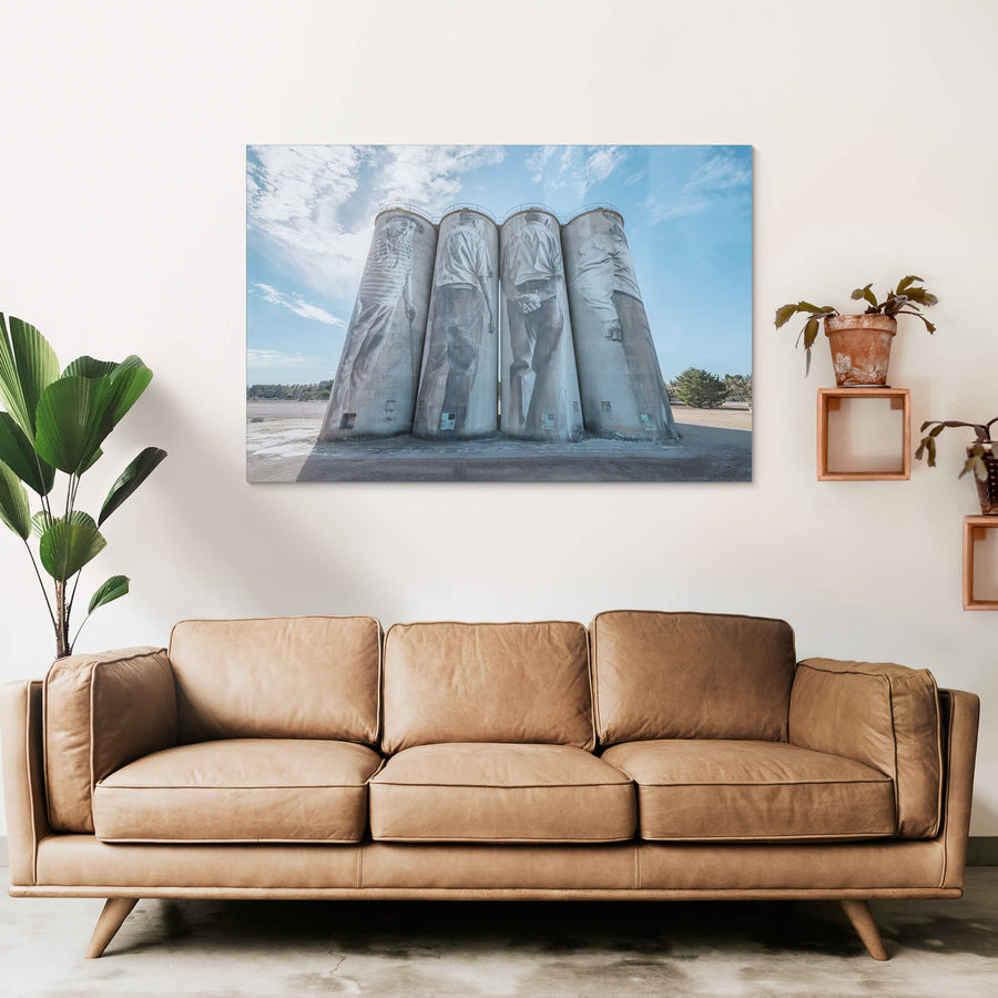 Silos at Portland Cement Works, four concrete silos stand in a row against open sky.