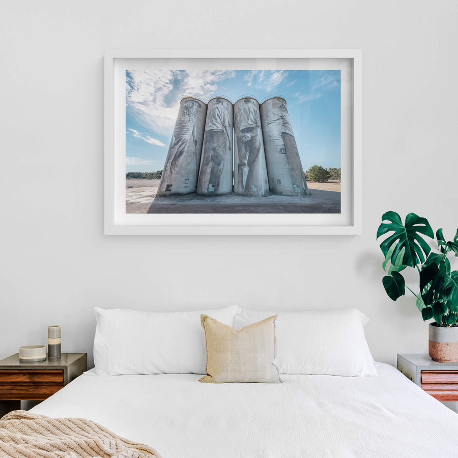 Silos at Portland Cement Works, four concrete silos stand in a row against open sky.