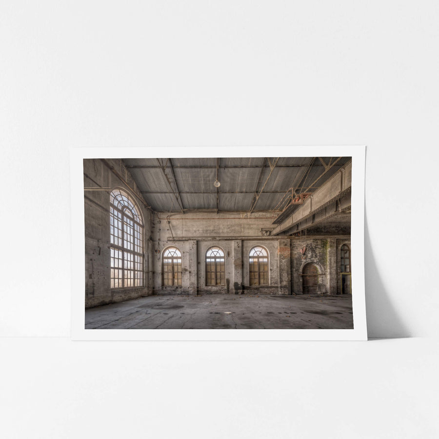 Small Arches at Portland Cement Works, three arched windows line the far wall, their semi-circular fanlights filtering pale.