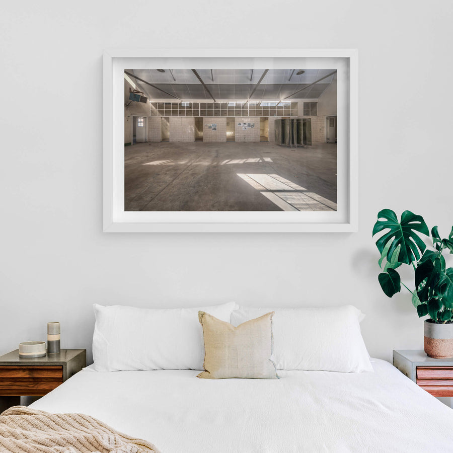 Wash House at Portland Cement Works, sunlight falls in clean geometric shapes across a concrete floor.