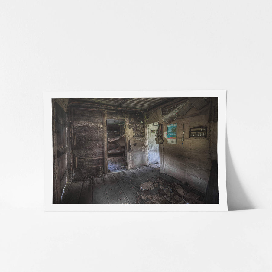 Back Room Entry at Woolla, corrugated iron roofing sits low over rough-hewn timber walls lined with hessian.