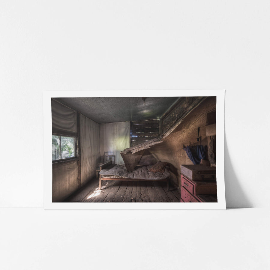 Rear Bedroom at Woolla, a single bed sits against the back wall, its striped mattress sagging under a collapsed sheet.