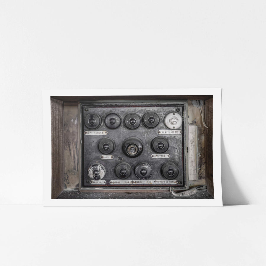 Downstairs Light Switches at Terminus Hotel, a grid of Bakelite light switches remains mounted to the wall, each paired.