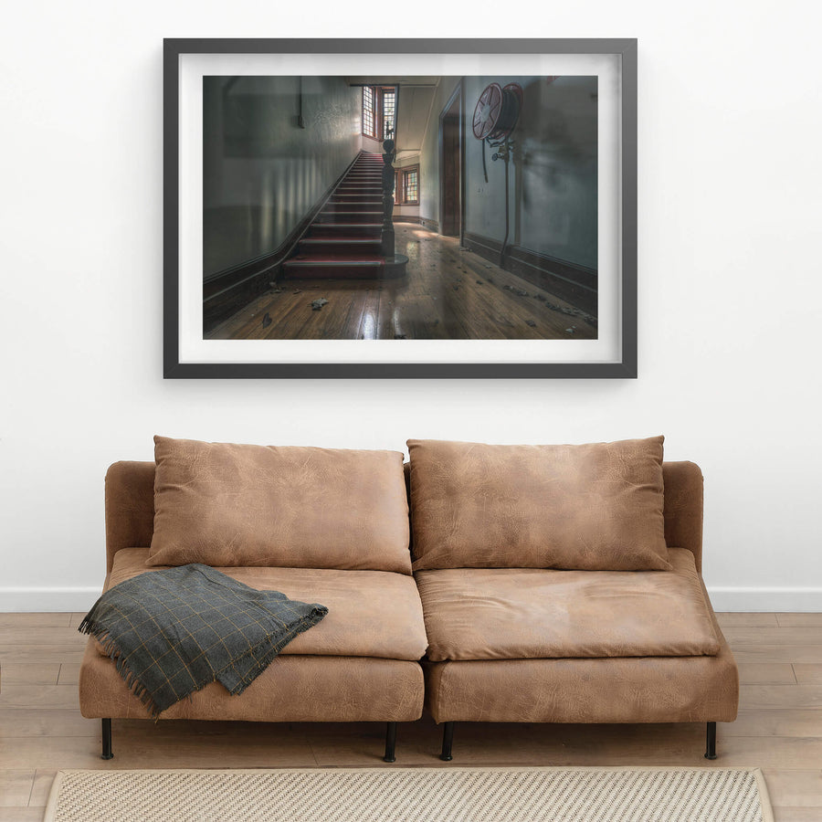 Administration Staircase at The Asylum, a carpeted staircase rises from a ground-floor hallway, its turned newel post.