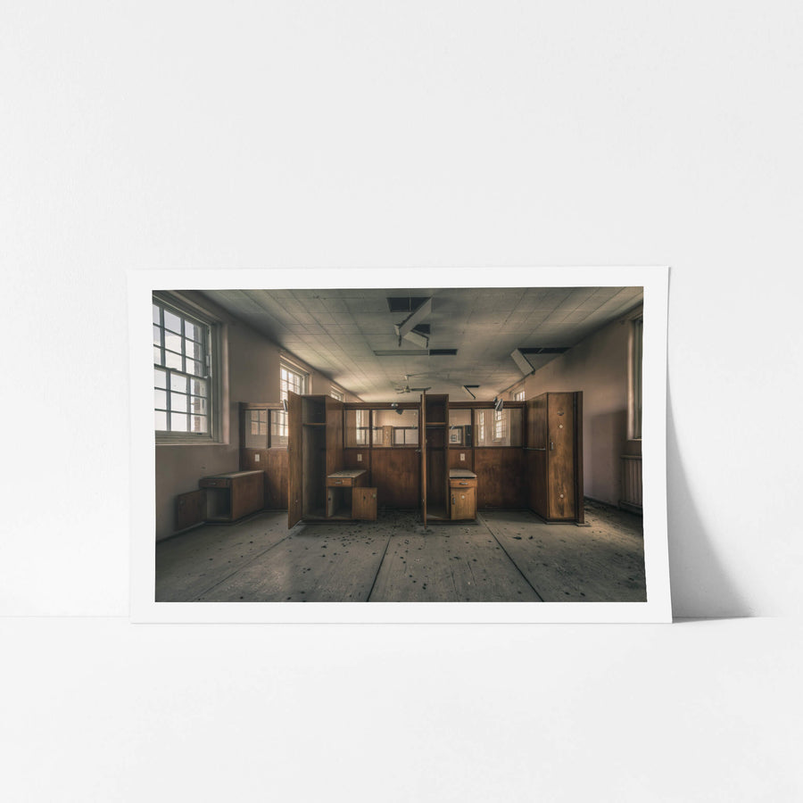 Divide at The Asylum, timber wardrobes and bedside cabinets stand open in two rows, dividing the room into narrow cubicles.