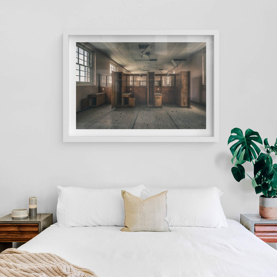 Divide at The Asylum, timber wardrobes and bedside cabinets stand open in two rows, dividing the room into narrow cubicles.