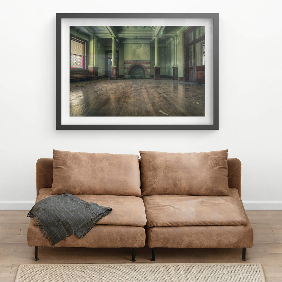 Fireplace at The Asylum, a wide formal room with pale green walls and coffered ceilings.