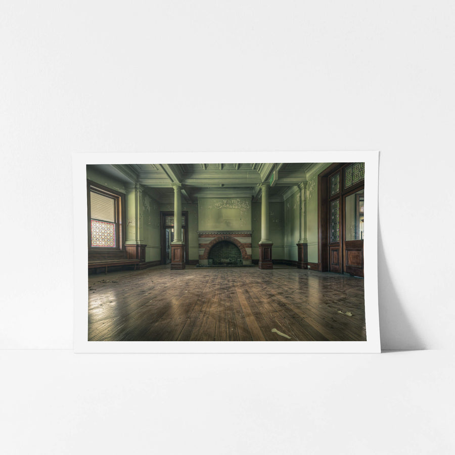 Fireplace at The Asylum, a wide formal room with pale green walls and coffered ceilings.