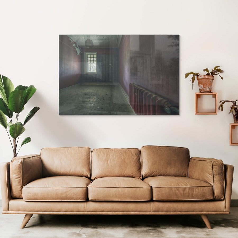 Heater at The Asylum, a cast-iron column radiator sits against the far wall, painted the same deep oxblood as the room.