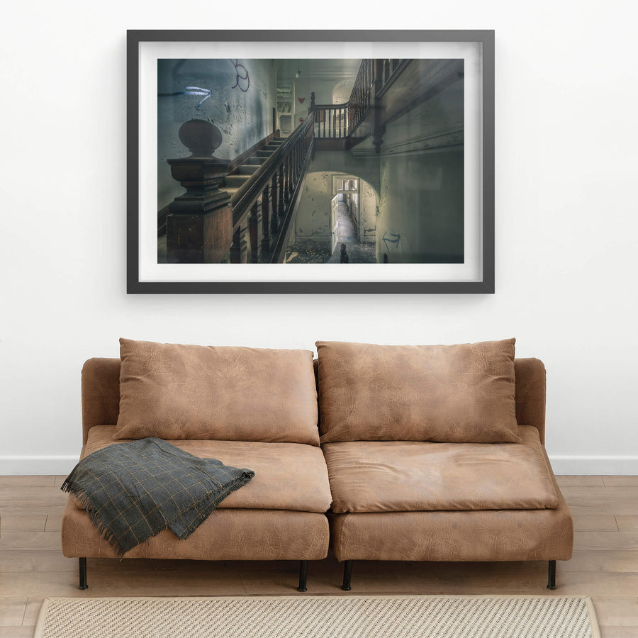 Intermission at The Asylum, a dark timber balustrade climbs through the centre of the stairwell, its turned spindles still.