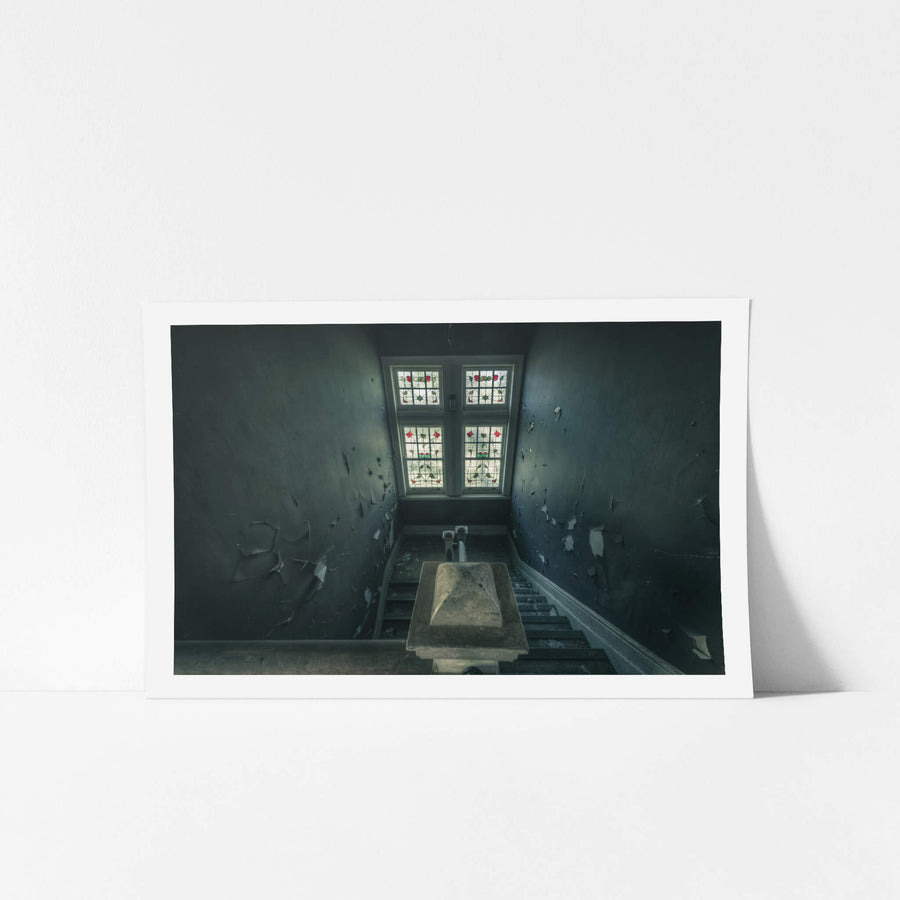 Leadlight Stairs at The Asylum, a stairwell narrows toward a four-panel leadlight window.