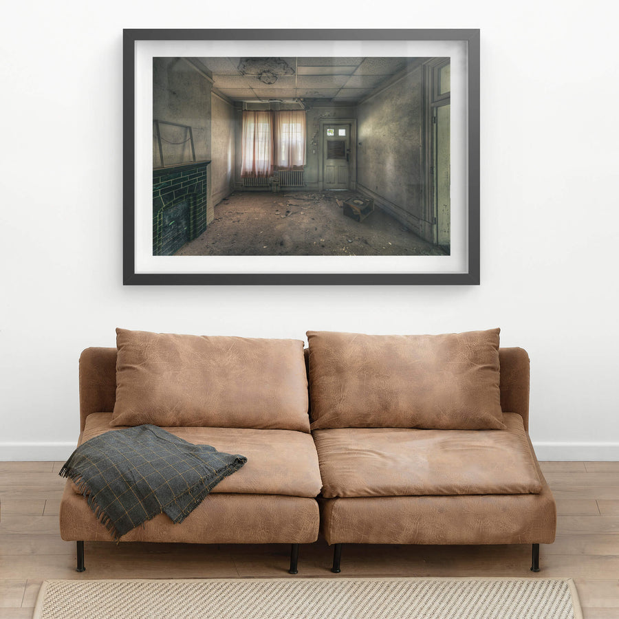 Recreation Room at The Asylum, faded pink curtains filter grey light through a pair of windows.