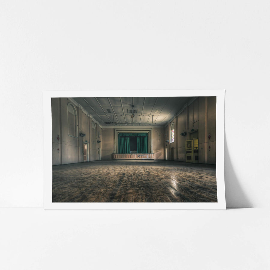 Setting the Stage at The Asylum, a green curtain hangs closed across the proscenium stage.