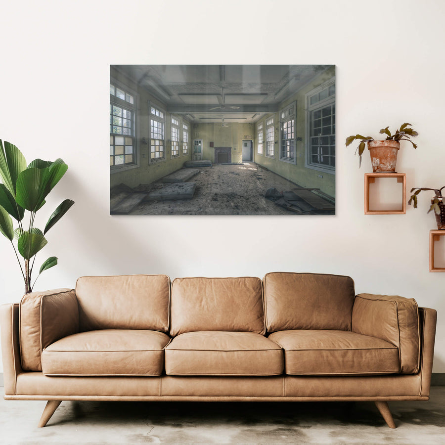 Spare Beds at The Asylum, a large common room with pale yellow walls and white-trimmed windows on three sides.