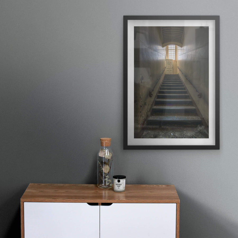 Stairs Up at The Asylum, a narrow stairwell climbs steeply between close walls.