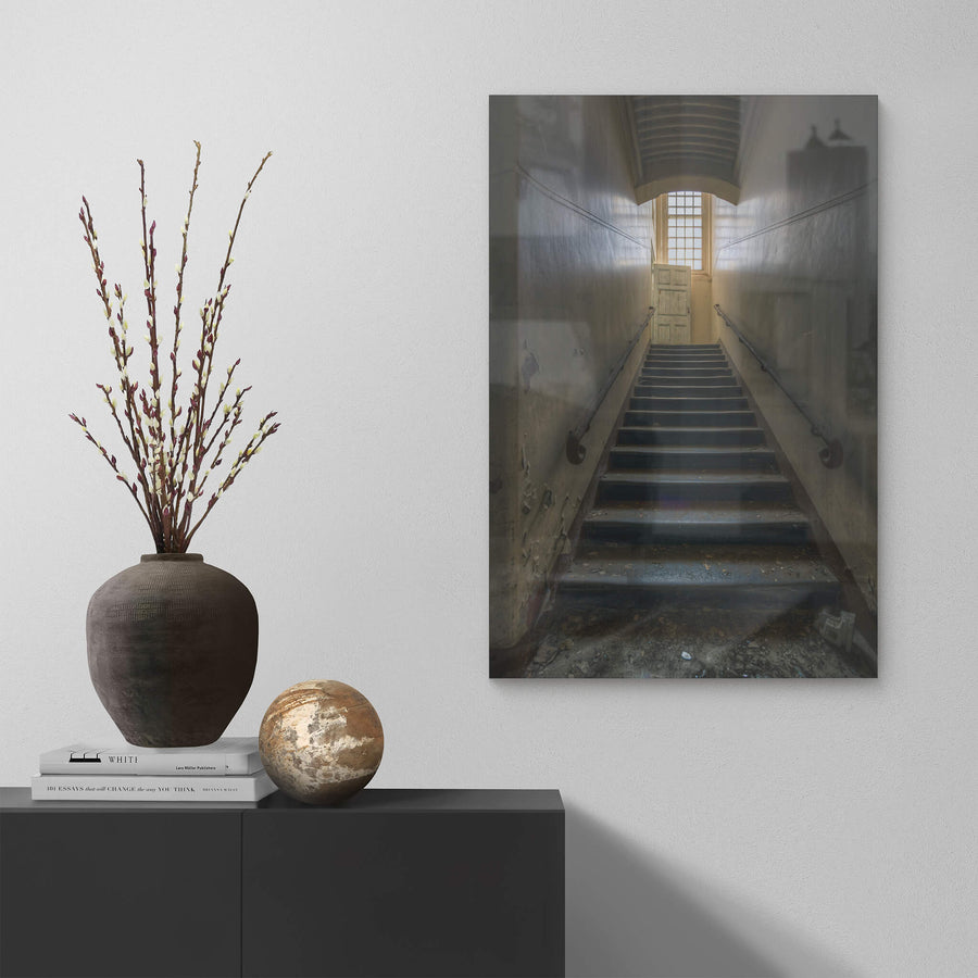 Stairs Up at The Asylum, a narrow stairwell climbs steeply between close walls.
