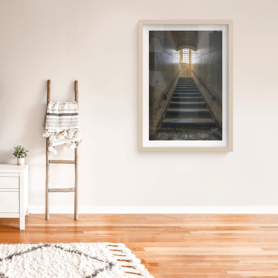 Stairs Up at The Asylum, a narrow stairwell climbs steeply between close walls.