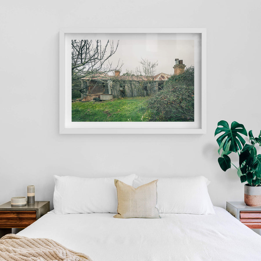 Backyard at The Post Office, weathered timber and corrugated iron form the rear wall of a low rural homestead.