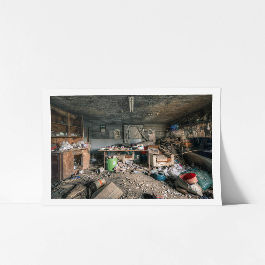 Dining Area at The Post Office, a low timber ceiling, blackened with mould, presses down over a single room.