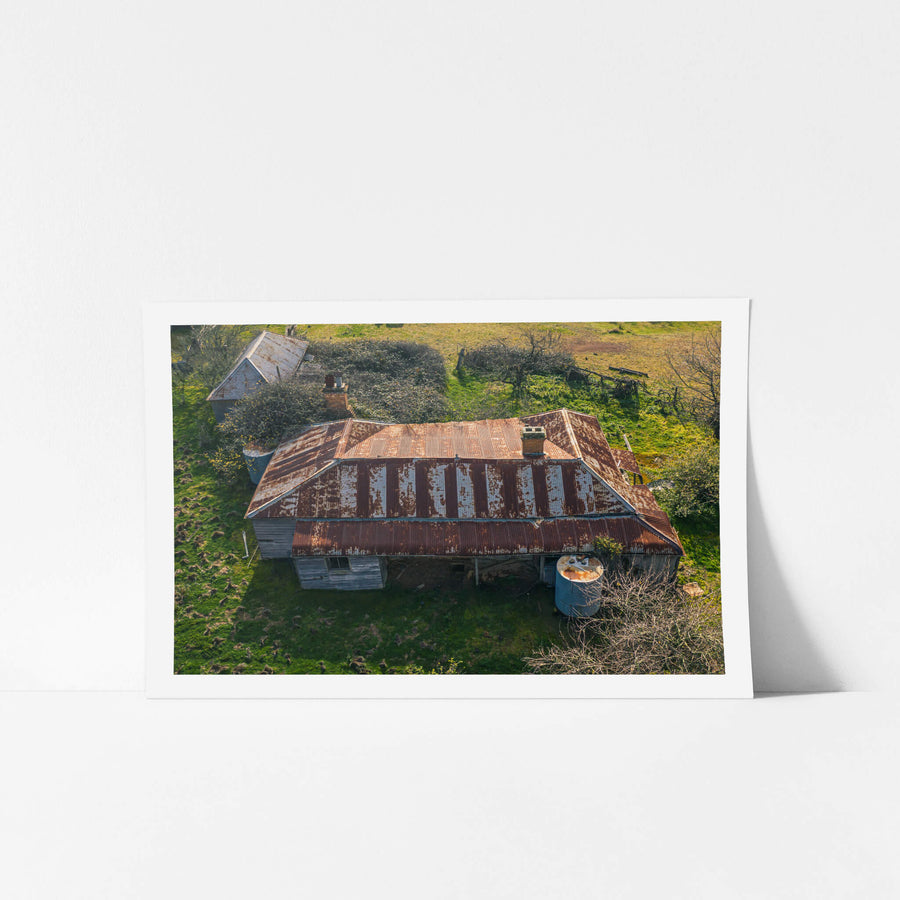 Front Elevated at The Post Office, from above, the building's hipped roof spreads wide across green pasture.
