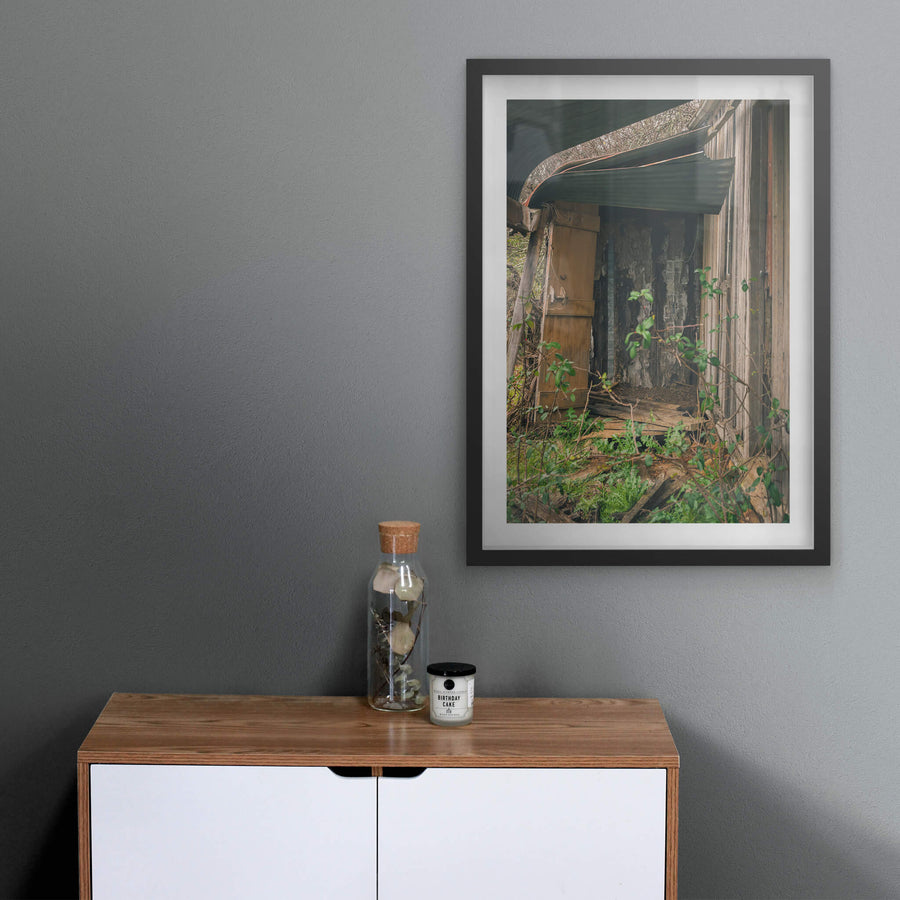 Verandah at The Post Office, a green corrugated iron roof bows away from the timber frame, pulling free at the edge.