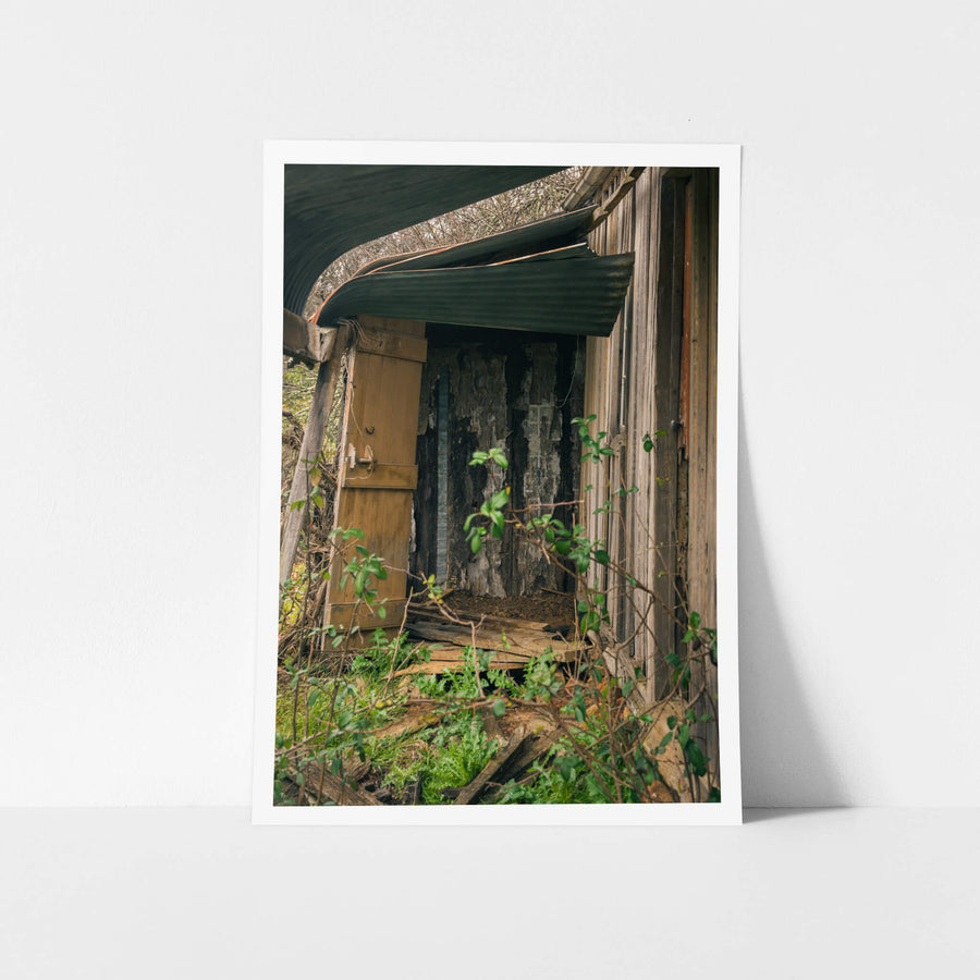 Verandah at The Post Office, a green corrugated iron roof bows away from the timber frame, pulling free at the edge.