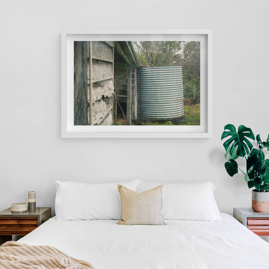 Water Tank at The Post Office, a corrugated steel water tank sits tight against the back corner of a timber outbuilding.
