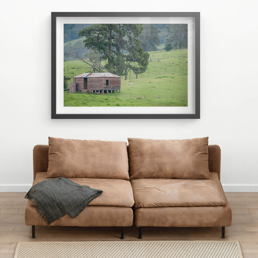 Bemboka Woolshed at The Woolshed, a weatherboard woolshed sits on low timber stumps against a slope of green pasture.