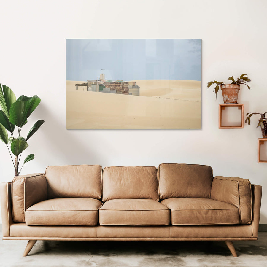Buried at Tin City, a Tin City shack, recessed in rolling dunes of sand.